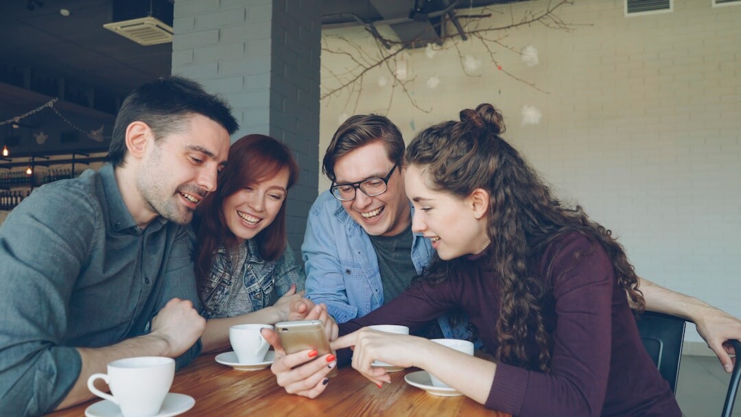 people using smartphones in cafe